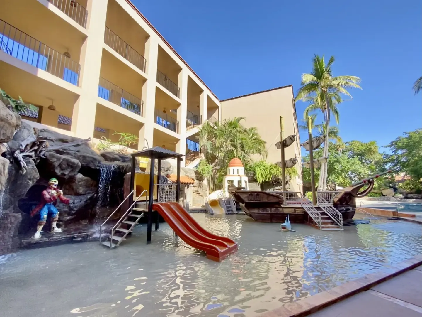 Children's pool area with slides, a pirate ship, and a waterfall at Hotel Playa Mazatlan.