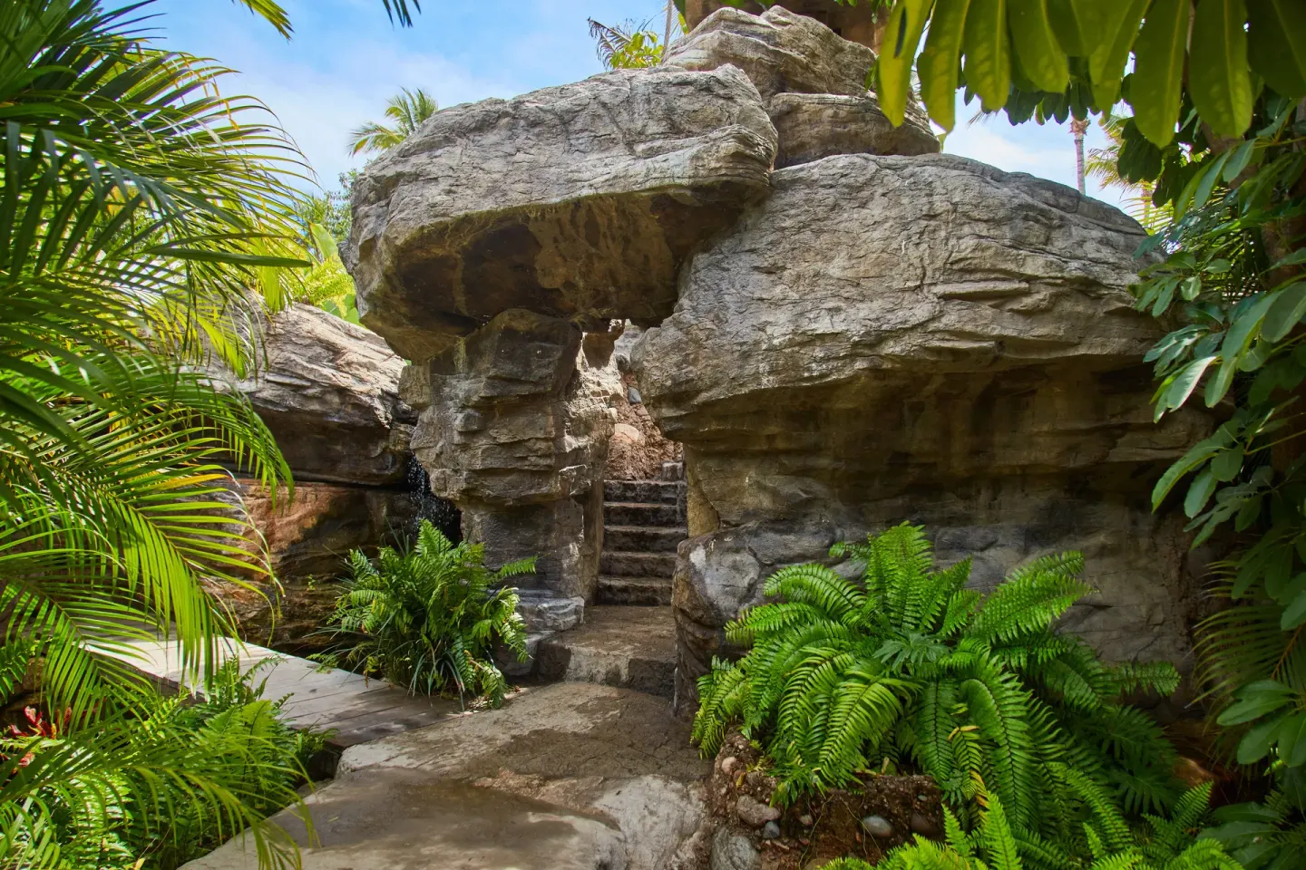Rock grotto walkway with ferns and palms at Hotel Playa Mazatlan.