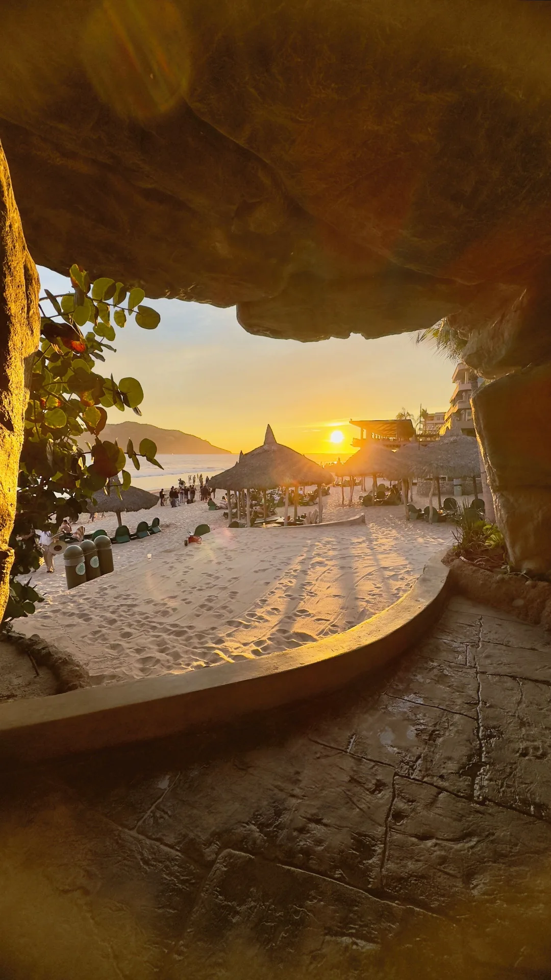 Sunset beach view through a rocky passage at Hotel Playa Mazatlan.