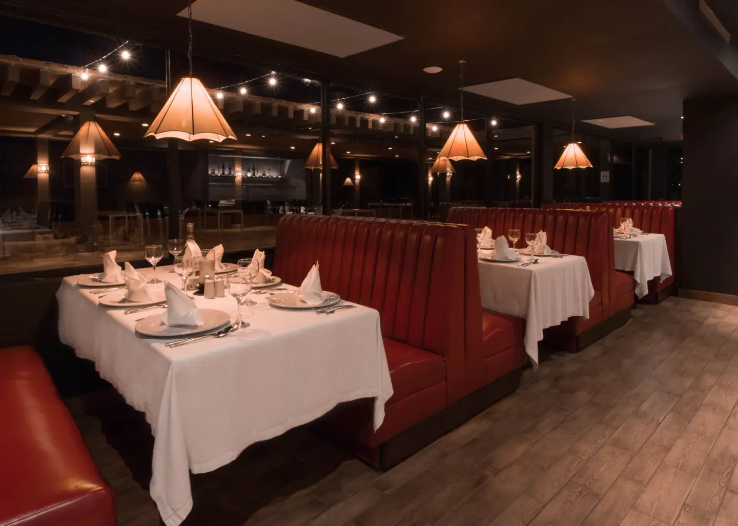 Dining room with red booths and white tablecloths at Hotel Playa Mazatlan.