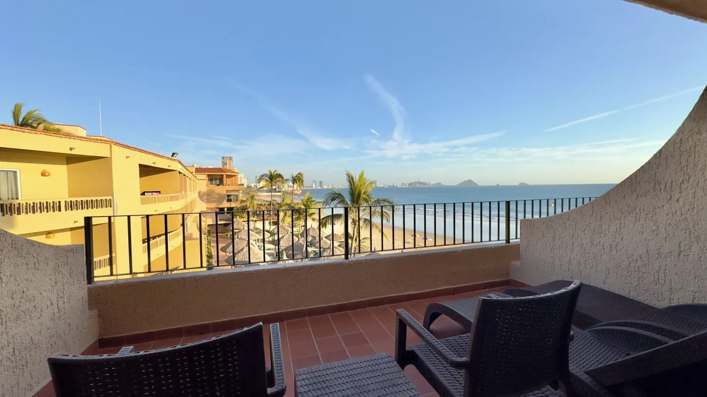 Guest room terrace with chairs and ocean view at Hotel Playa Mazatlan.