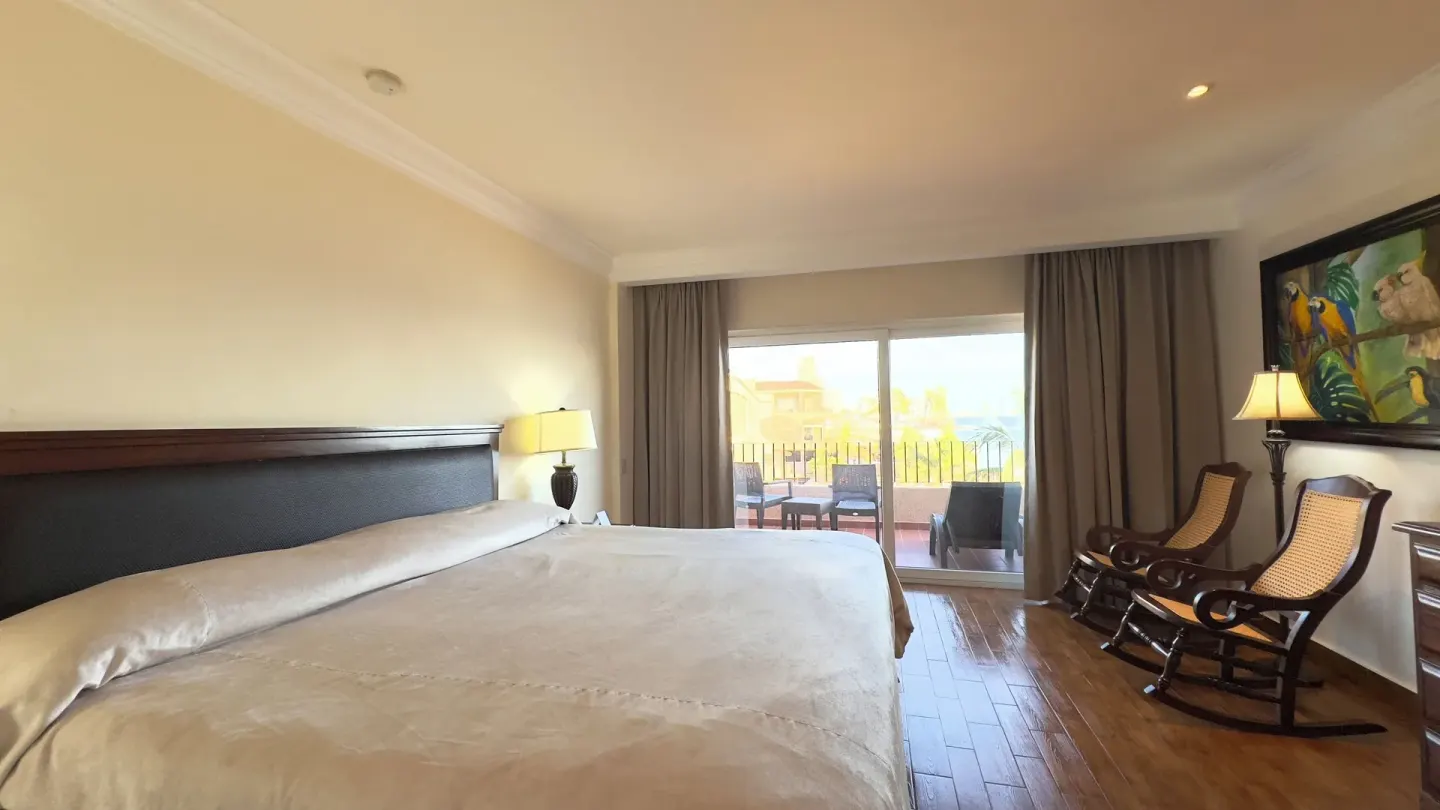 One-bed guest room with rocking chairs and balcony doors at Hotel Playa Mazatlan.