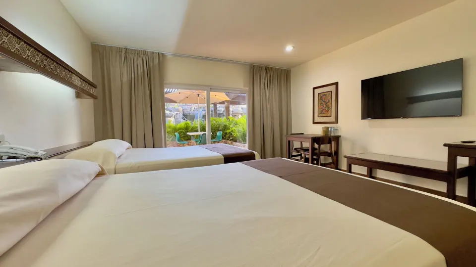 Standard room with two beds and wall TV at Hotel Playa Mazatlan.