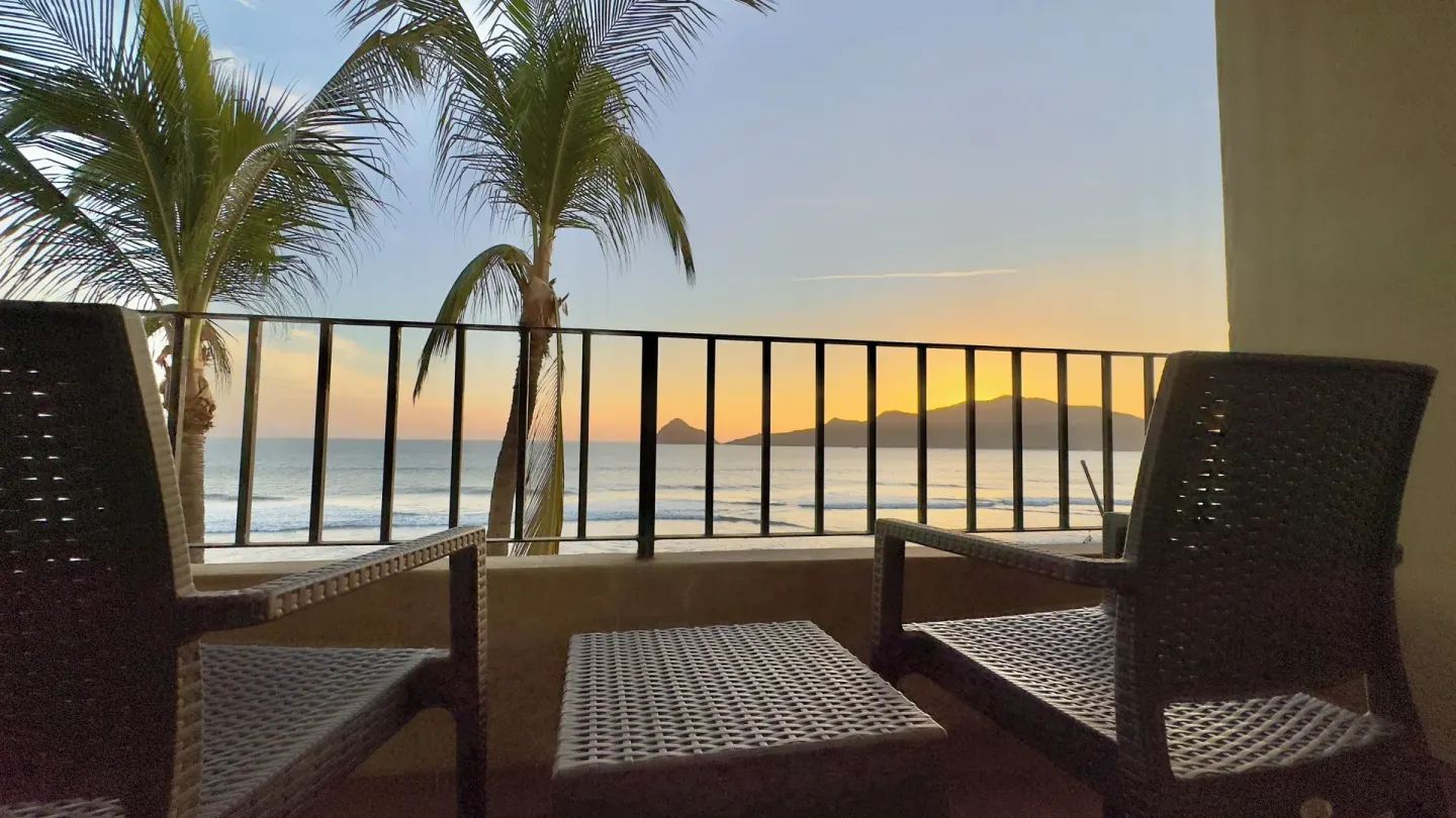 Balcony chairs facing sunset ocean view at Hotel Playa Mazatlan.