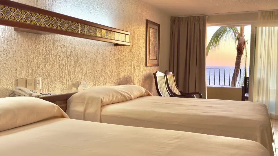 Standard ocean view room with two beds and balcony at Hotel Playa Mazatlan.