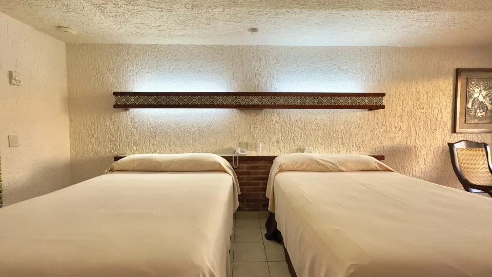 Front view of two beds and tile headboard detail at Hotel Playa Mazatlan.