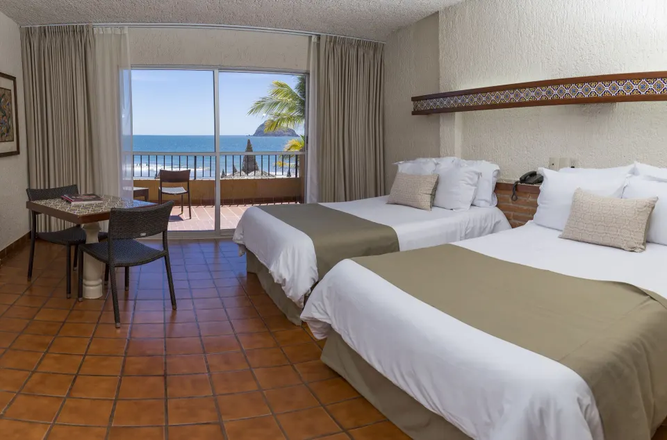 Standard ocean-view room with two beds and balcony at Hotel Playa Mazatlan.