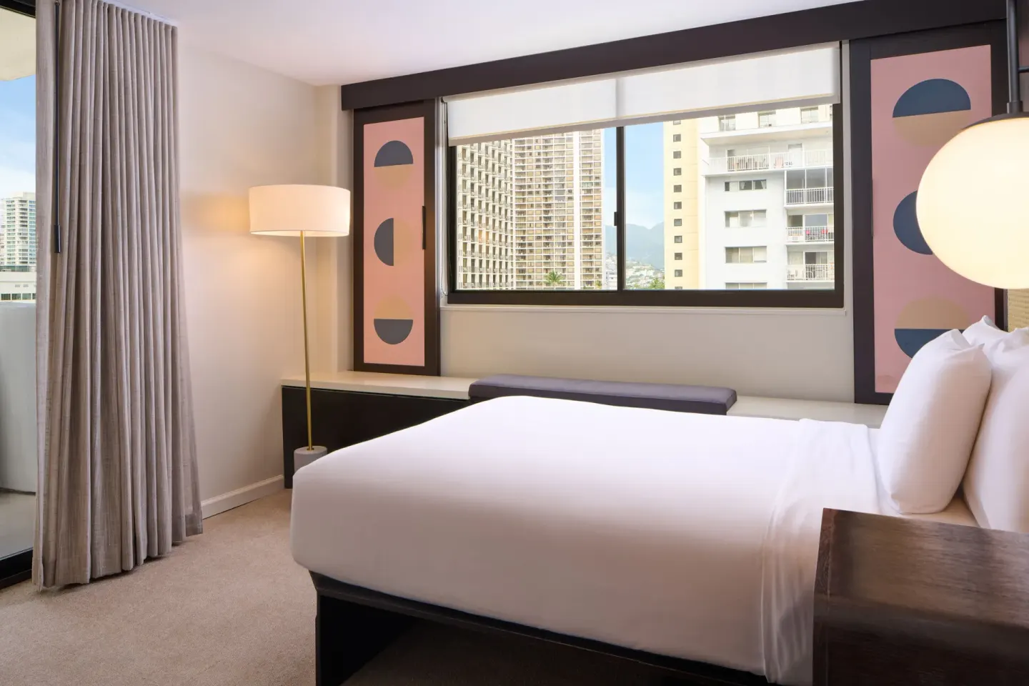 Standard Full guest room with full bed, window bench, and city views at Hotel Renew.