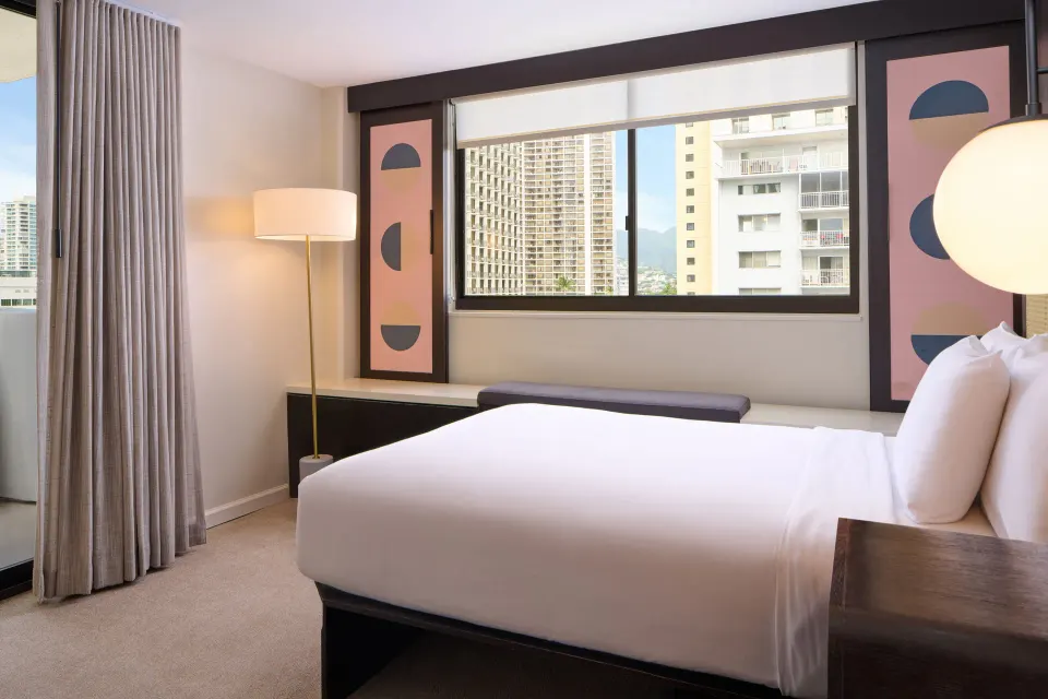 Standard Full guest room with full bed, window bench, and city views at Hotel Renew.