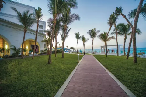 Palm-lined walkway leading toward the ocean at Hotel Riu Cancun.