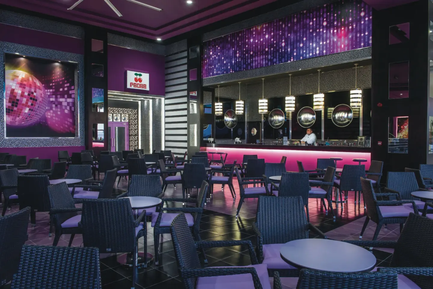 Pacha lounge seating and pink-lit bar at Hotel Riu Cancun.