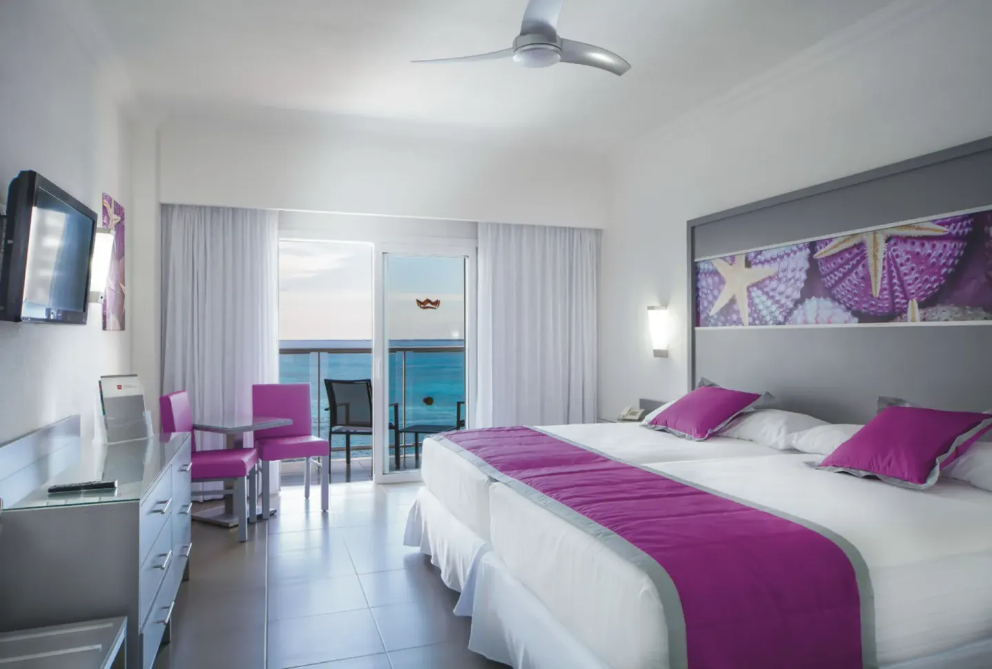 Standard Ocean View room with two beds and balcony at Hotel Riu Cancun.