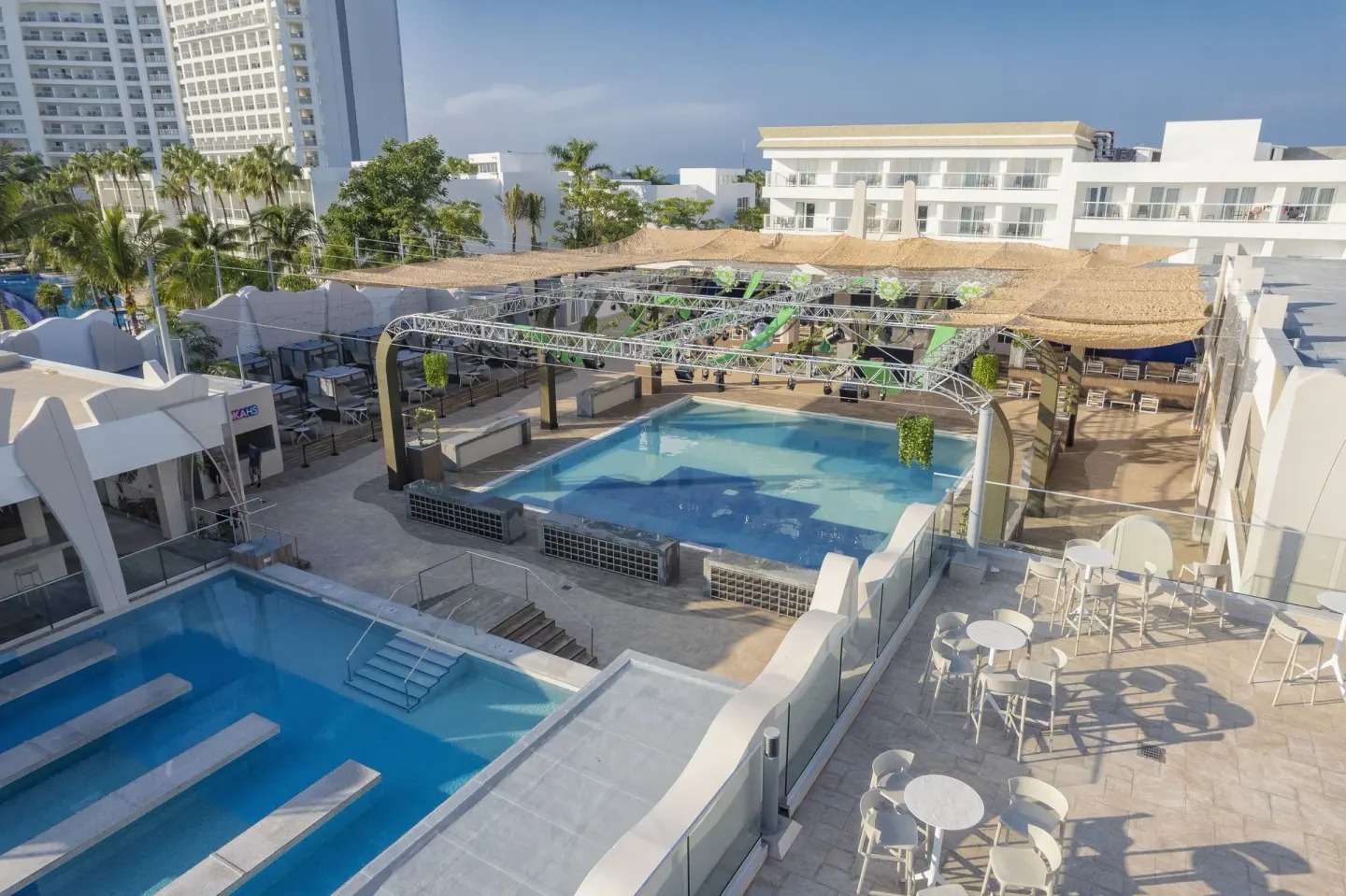 Elevated view of pools, stage area, and terraces at Hotel Riu Caribe.