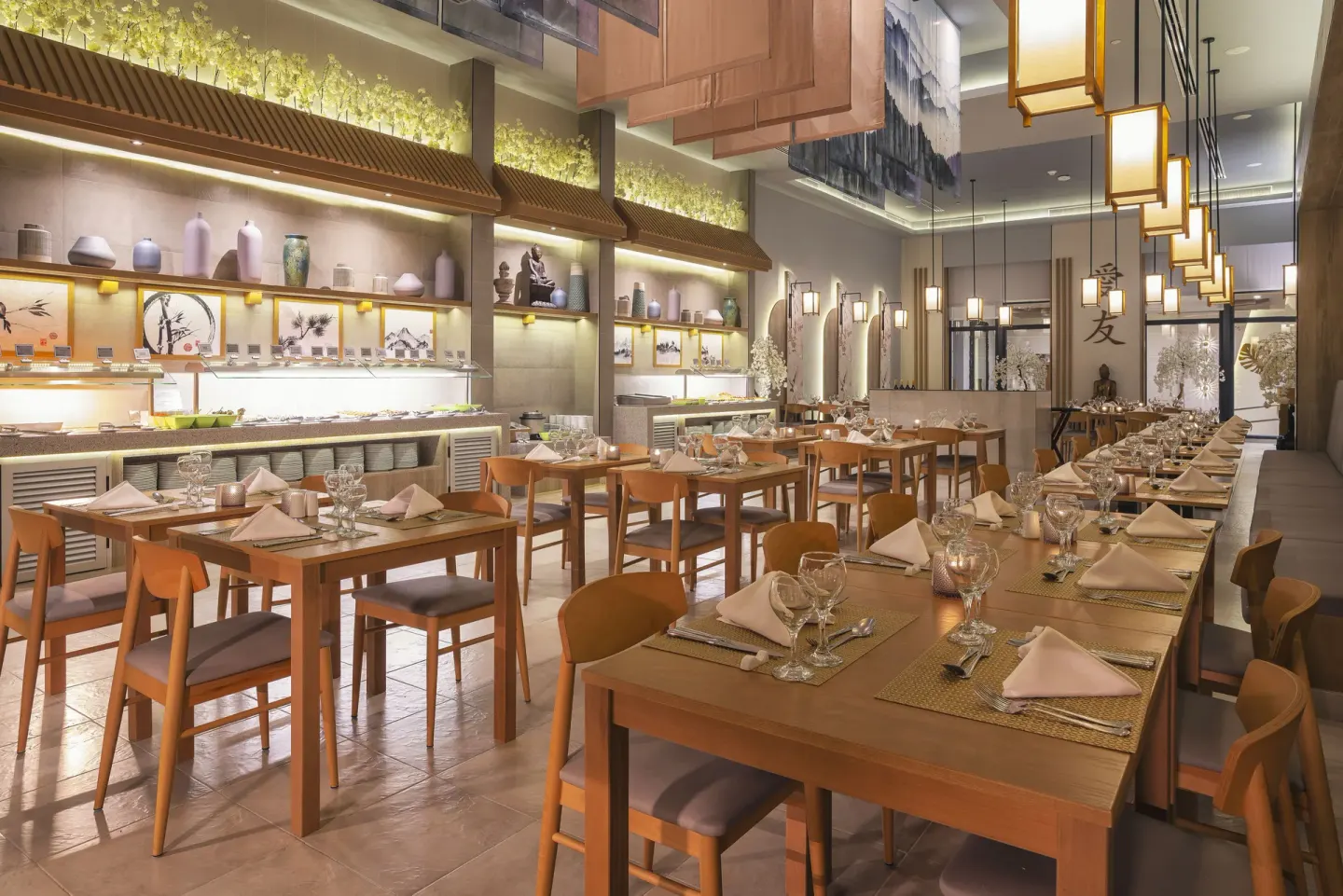 Asian-style restaurant with set tables, lantern lights, and buffet counter at Hotel Riu Caribe.