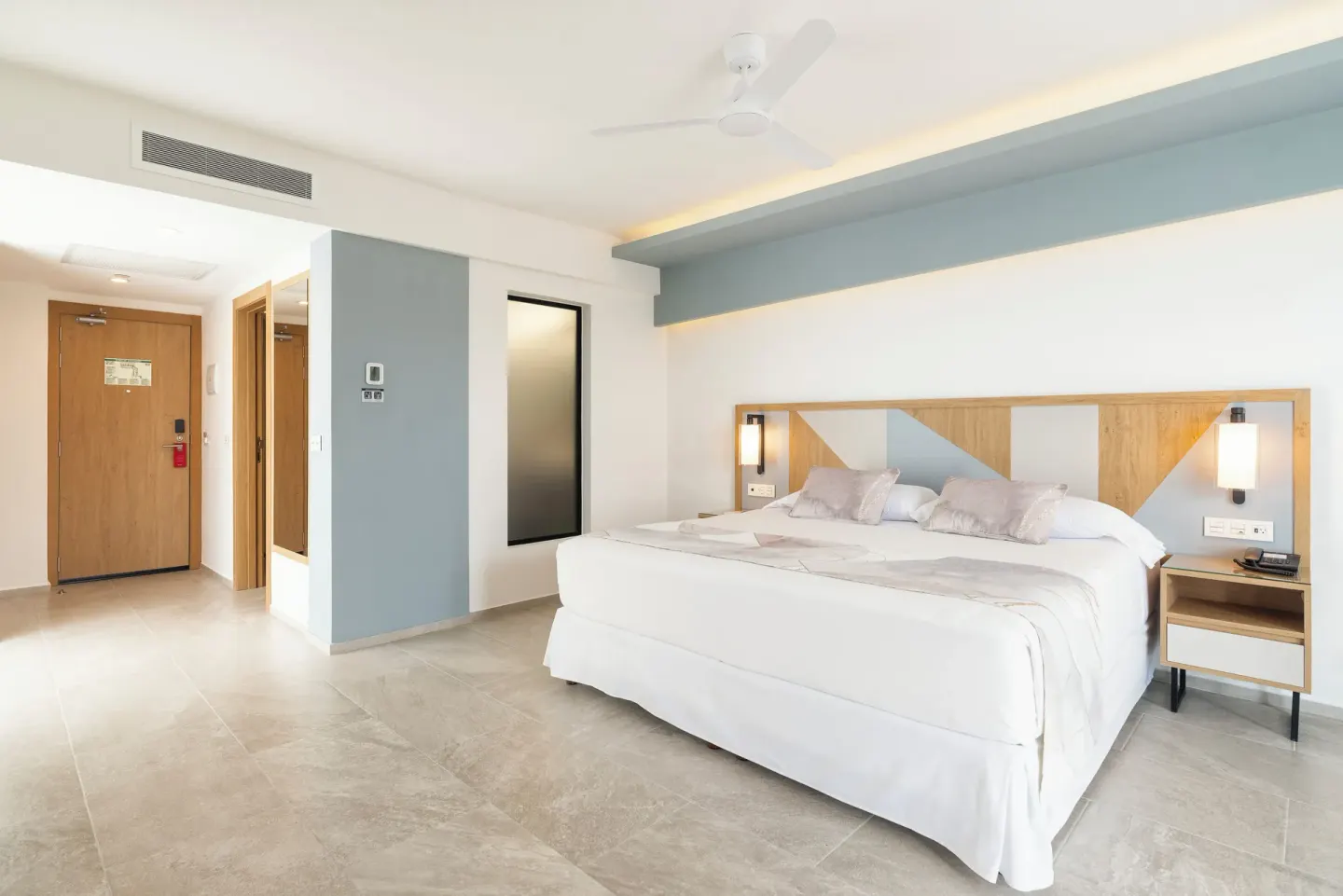 Junior Suite Oceanfront room with king bed and entry hall at Hotel Riu Caribe.