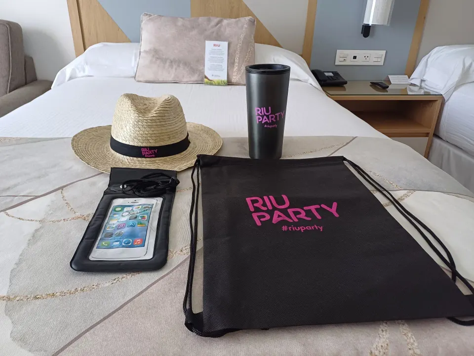Hotel Riu Caribe welcome items displayed on a bed at Hotel Riu Caribe.