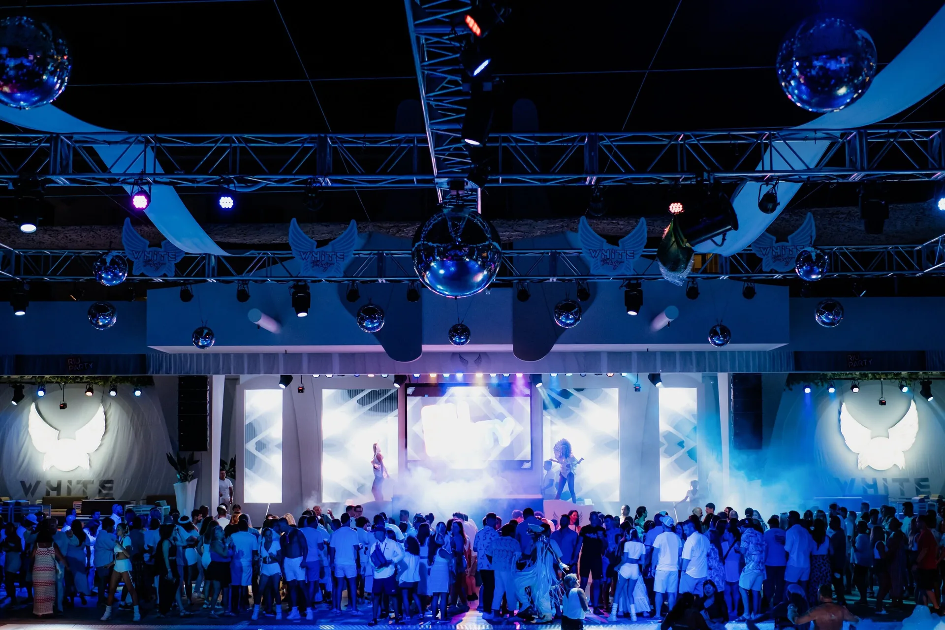 Guests gather for a nightclub-style stage show at Hotel Riu Caribe.
