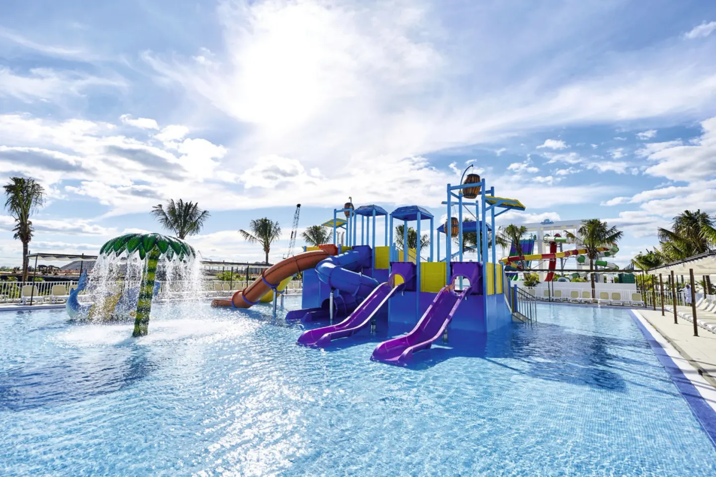 A children's splash pool with slides and water features at Hotel Riu Dunamar.