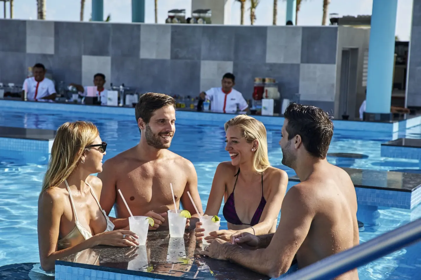 Guests with drinks at the swim-up bar at Hotel Riu Dunamar.