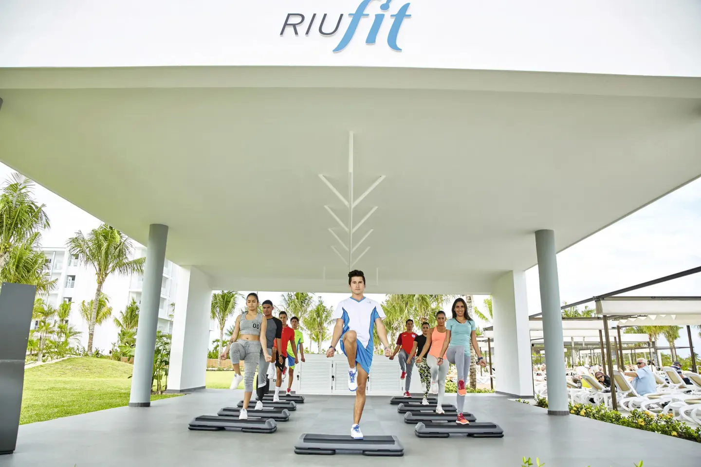 Step aerobics class beneath the outdoor fitness canopy at Hotel Riu Dunamar.