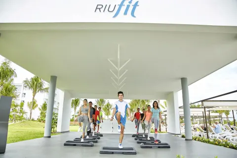 Step aerobics class beneath the outdoor fitness canopy at Hotel Riu Dunamar.