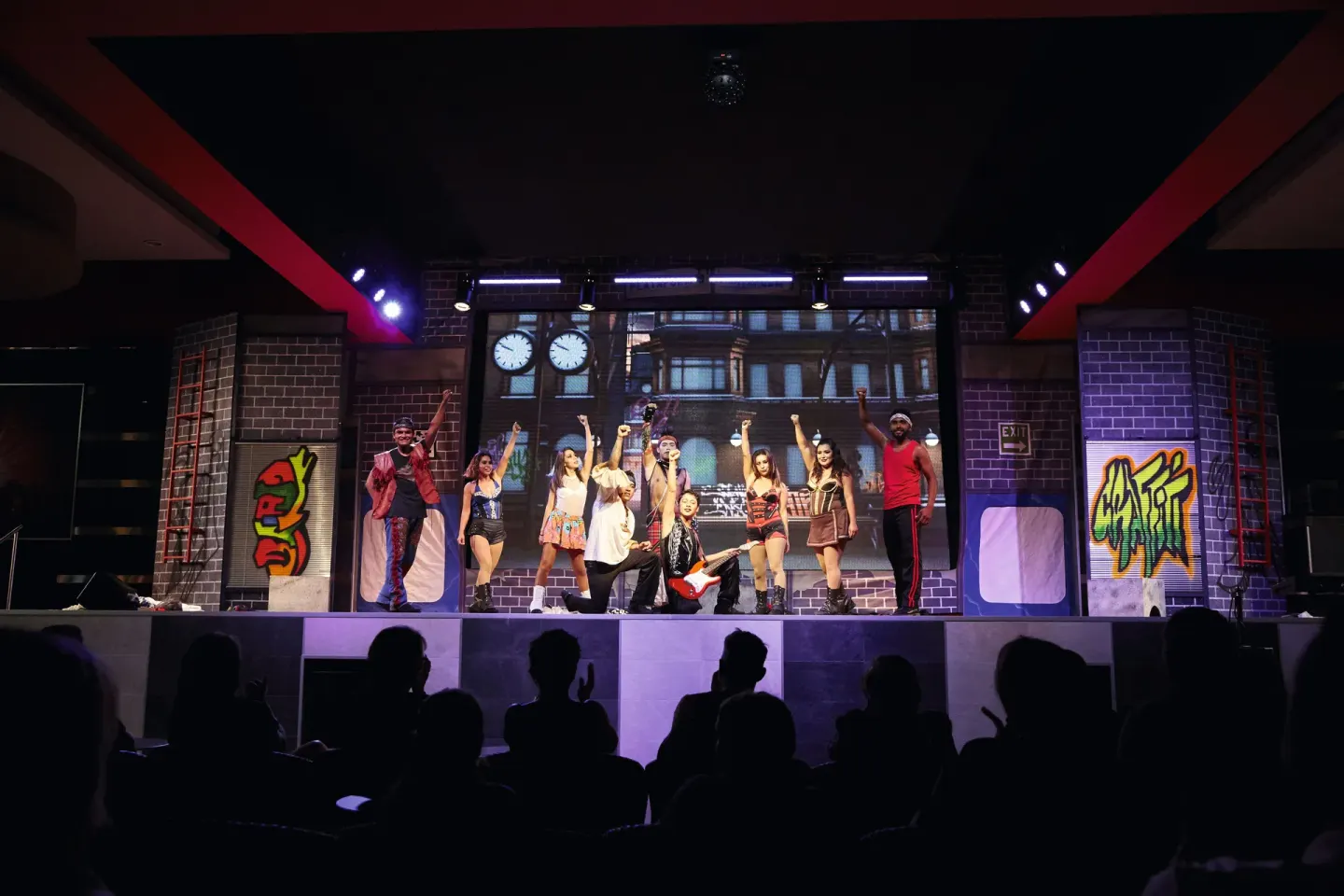 Cast members taking a bow on an indoor theater stage at Hotel Riu Dunamar.