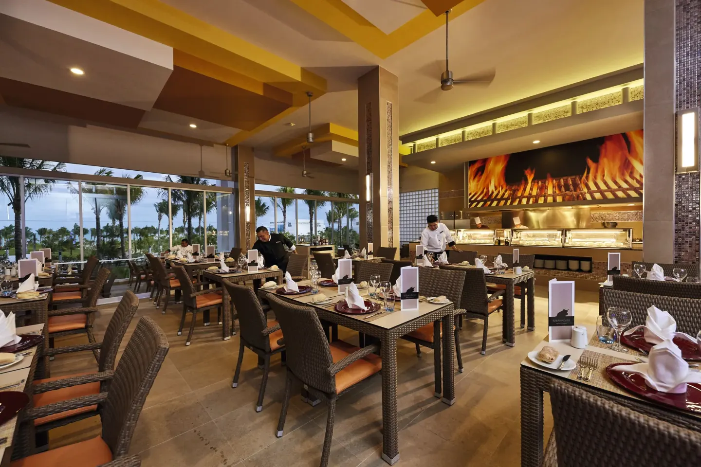 A set grill restaurant dining room with buffet counter at Hotel Riu Dunamar.