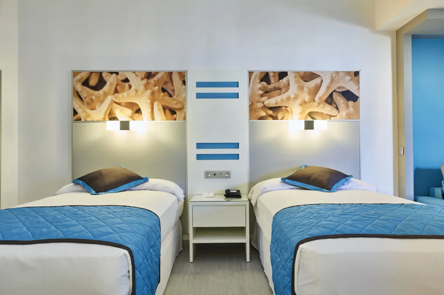 Family Suite twin beds with illuminated headboards at Hotel Riu Dunamar.
