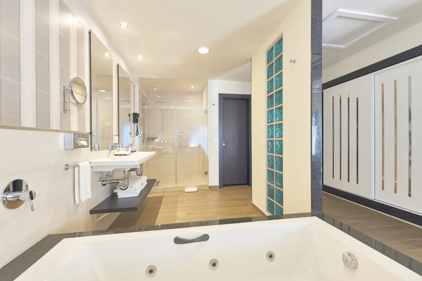 Suite bathroom with tub, vanity, and glass shower at Hotel Riu Dunamar.