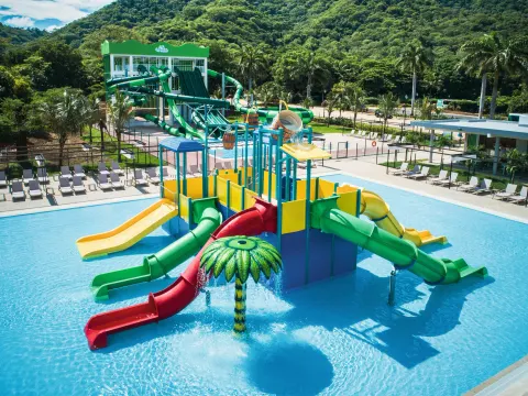 Children's splash pool with colorful slides at Hotel Riu Guanacaste.