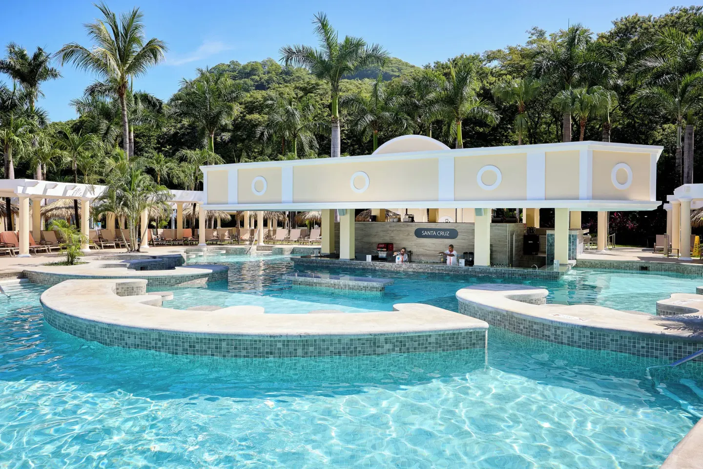 Santa Cruz swim-up bar surrounded by pool water at Hotel Riu Guanacaste.