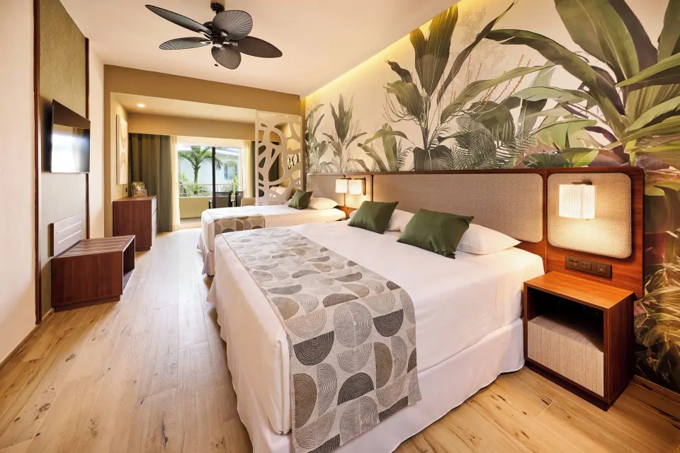 Family Room with two beds and balcony access at Hotel Riu Guanacaste.