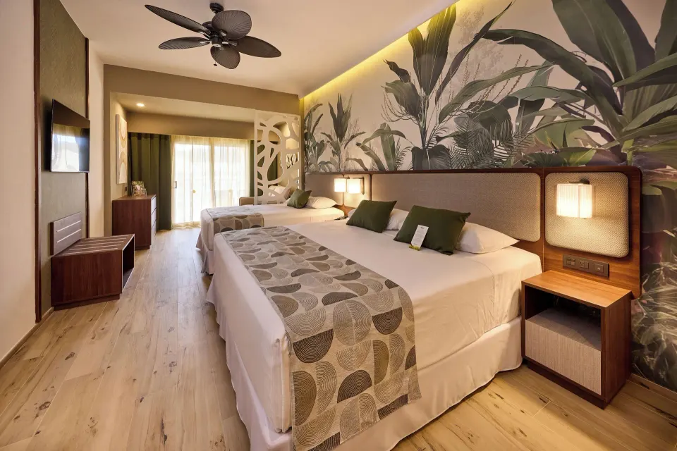Family Room with two beds and tropical wall mural at Hotel Riu Guanacaste.