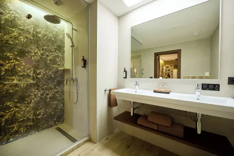 Standard Ocean View bathroom with glass shower and double sink at Hotel Riu Guanacaste.
