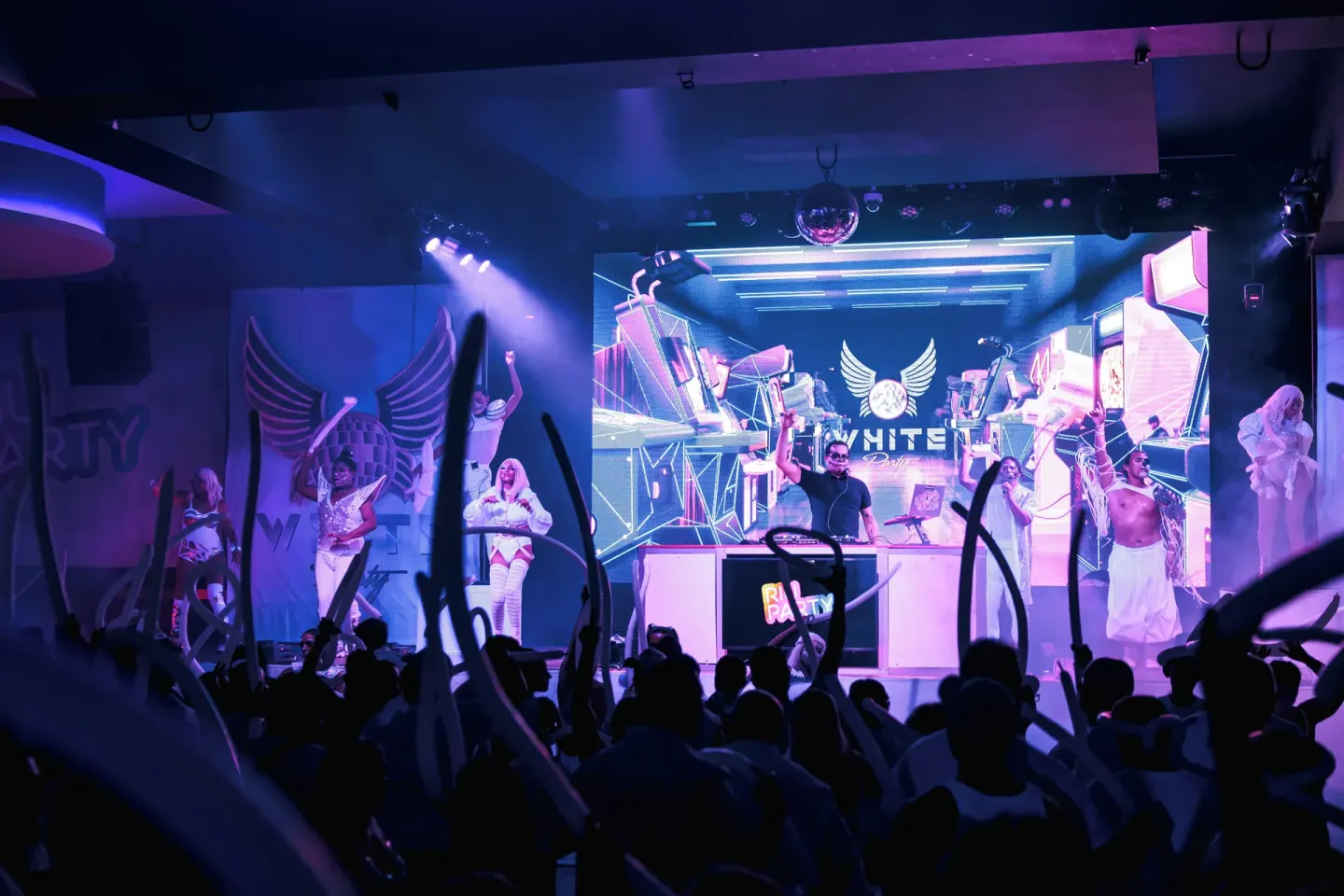 A DJ and performers entertain a crowd on stage at Hotel Riu Latino.