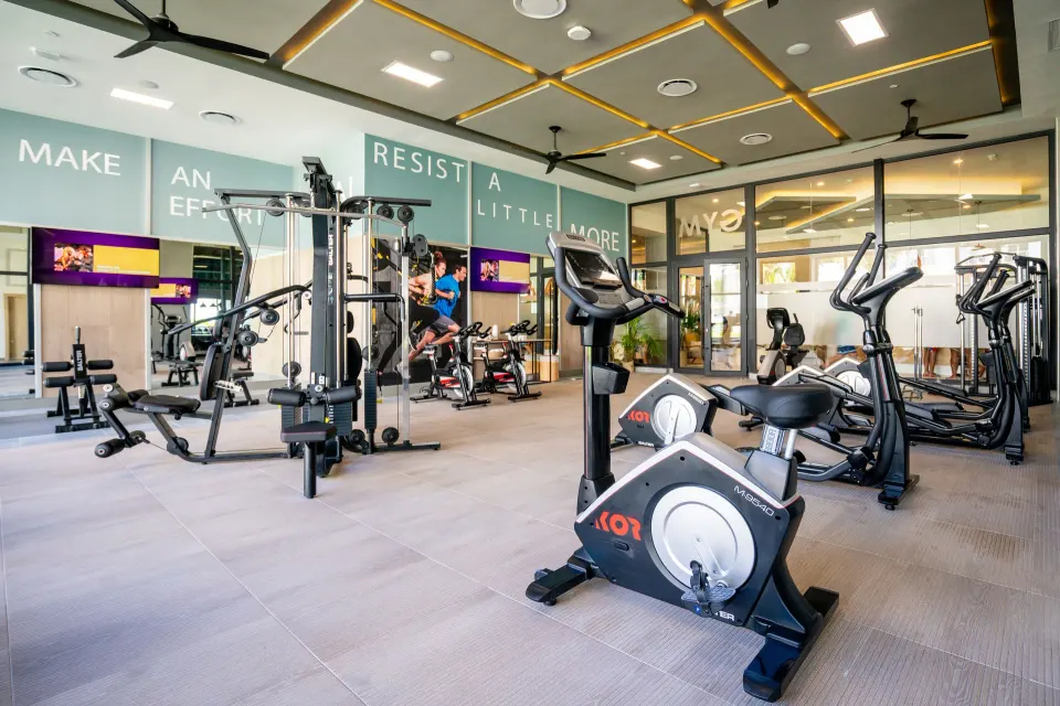 Gym with exercise bikes, cable machine, and cardio equipment at Hotel Riu Latino.