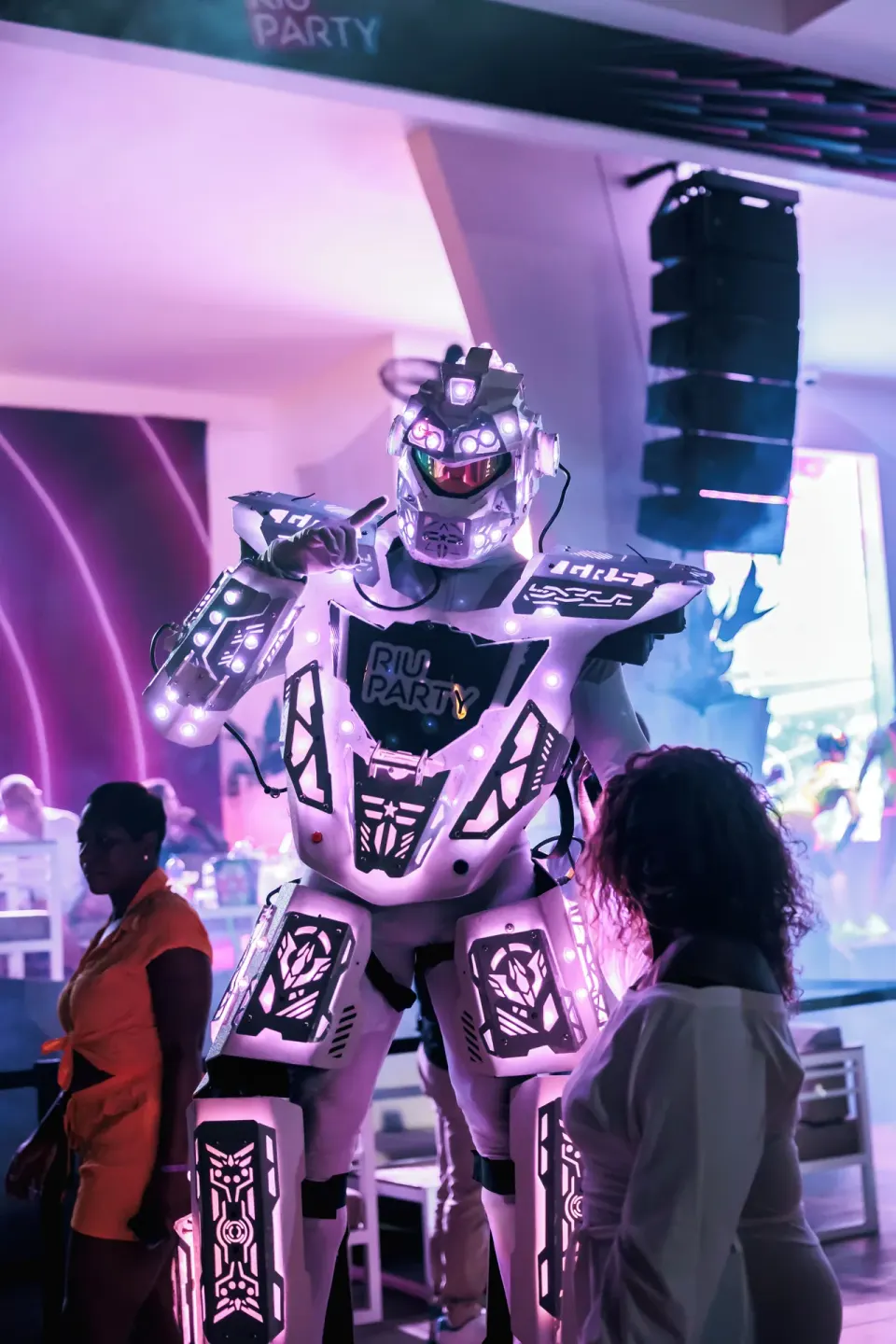 An illuminated robot costume performer greets guests at Hotel Riu Latino.