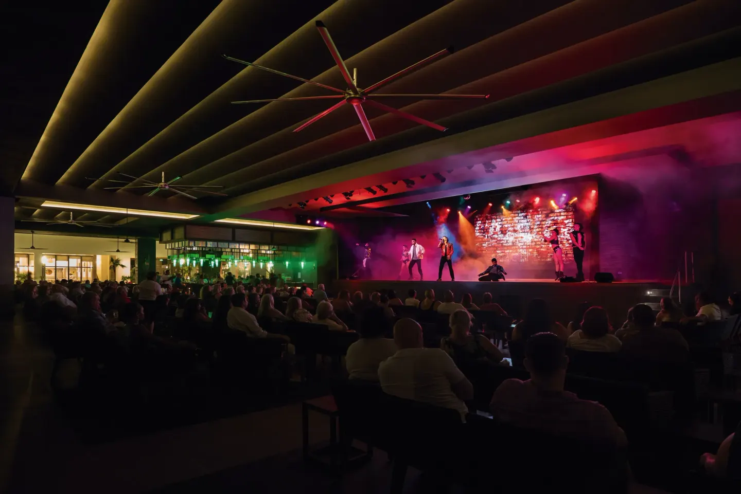 Guests watch a live stage show in an open-air theater at Hotel Riu Latino.