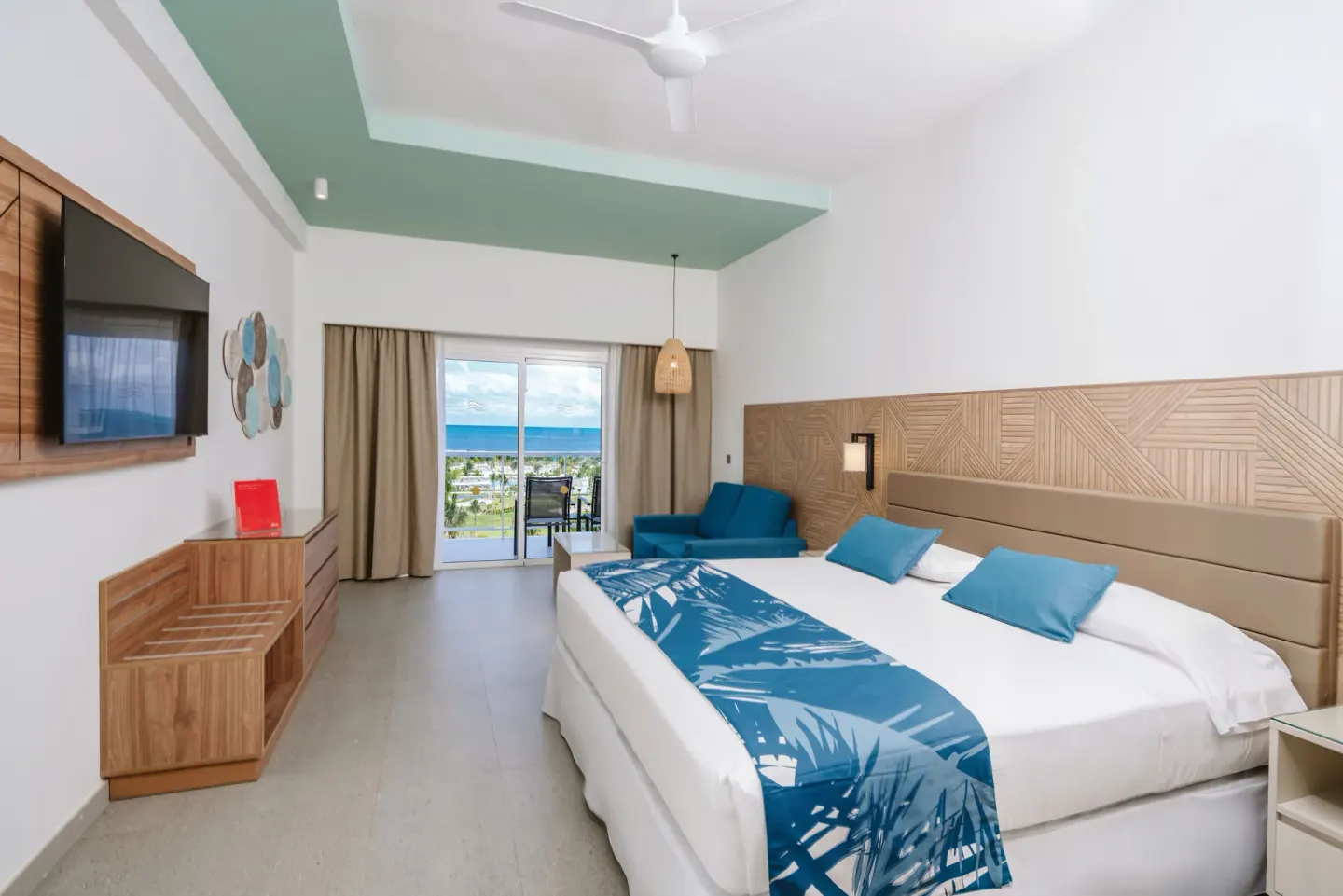 Ocean View Standard Room with king bed, sofa, and balcony at Hotel Riu Latino.
