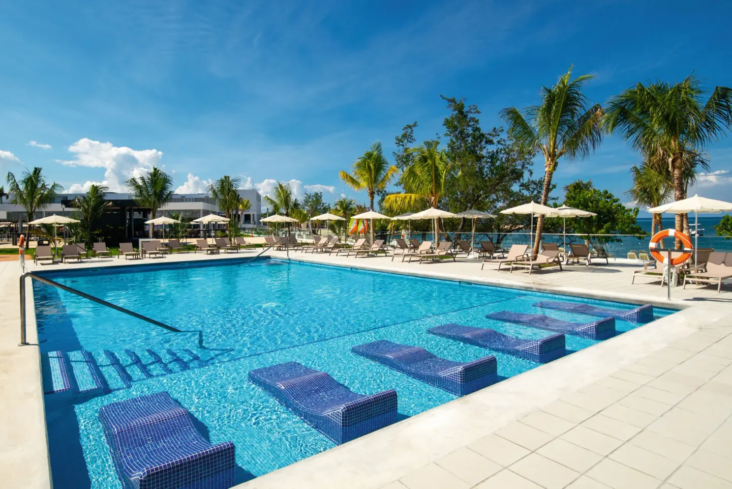 Main pool with in-water loungers and umbrellas at Hotel Riu Montego Bay.