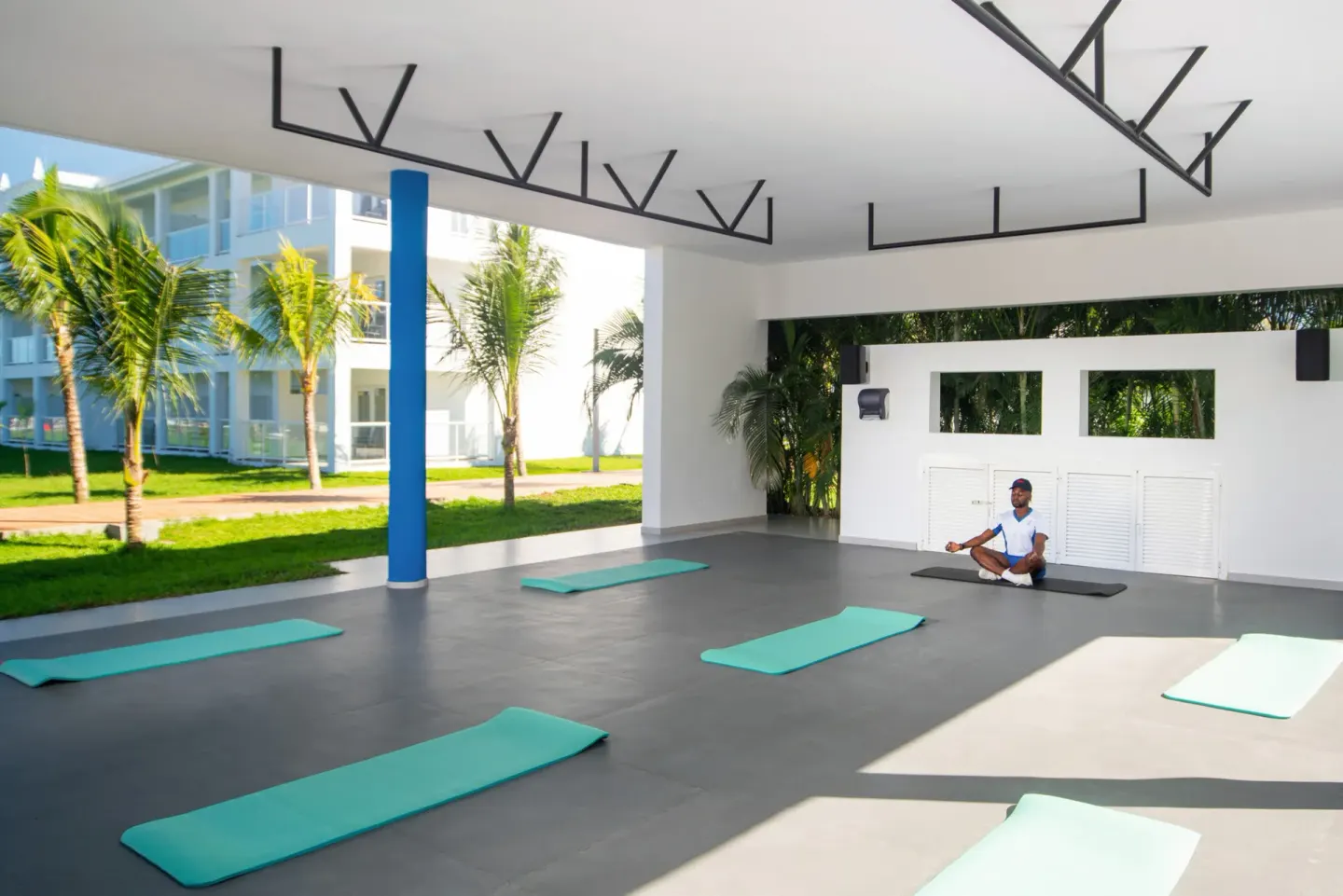 Open-air yoga area with mats and an instructor at Hotel Riu Montego Bay.
