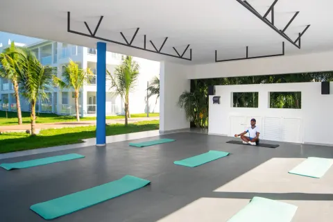 Open-air yoga area with mats and an instructor at Hotel Riu Montego Bay.