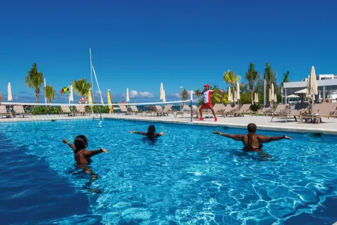 Pool fitness class with instructor beside the water at Hotel Riu Montego Bay.