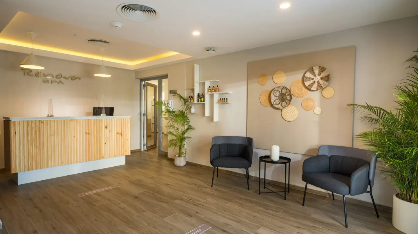 Spa reception with seating and woven wall decor at Hotel Riu Montego Bay.