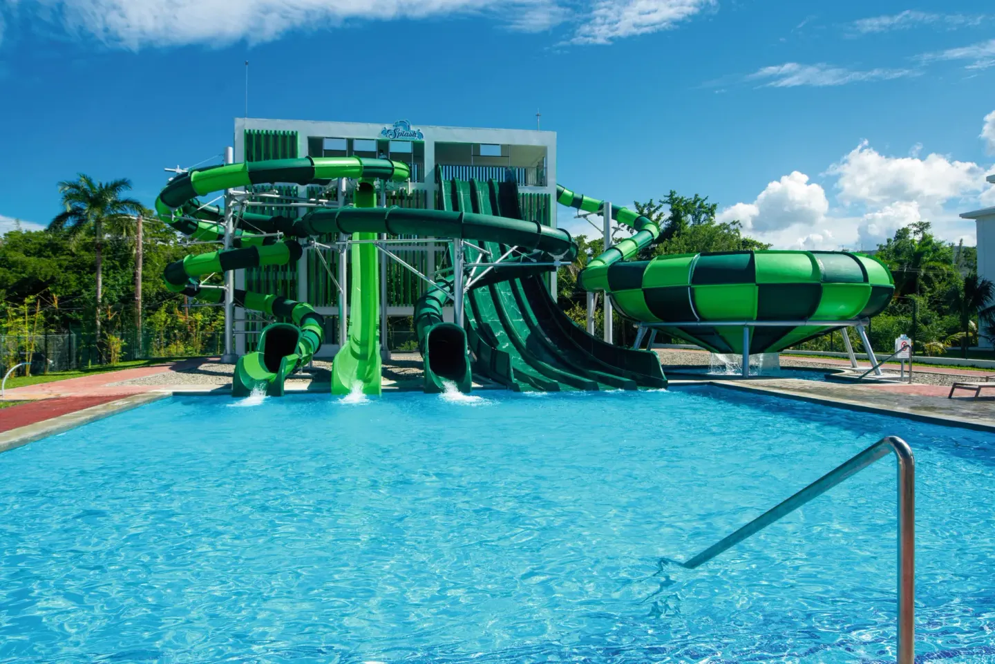 Green waterslide complex emptying into a pool at Hotel Riu Montego Bay.