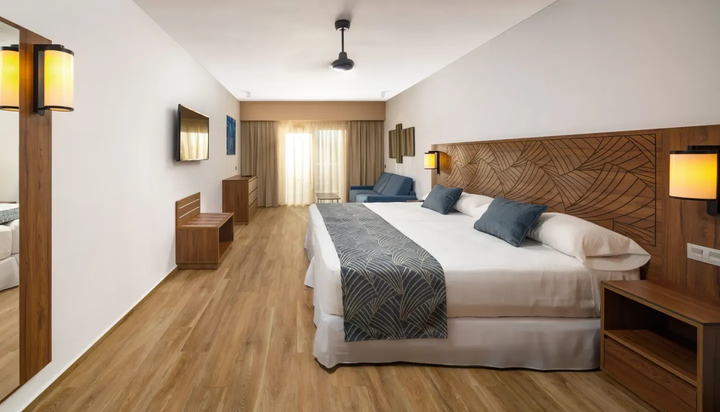 Family Room with two beds and seating area at Hotel Riu Montego Bay.