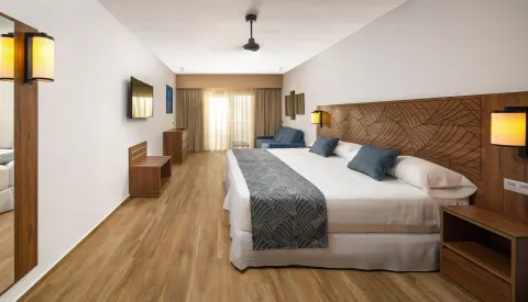 Family Room with two beds and seating area at Hotel Riu Montego Bay.