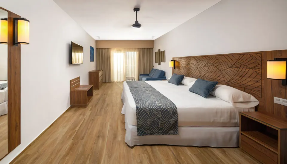 Family Room with two beds and seating area at Hotel Riu Montego Bay.