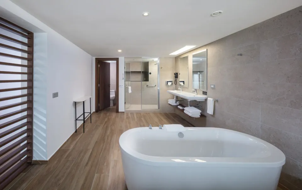 Suite Ocean View bathroom with freestanding tub and double vanity at Hotel Riu Montego Bay.
