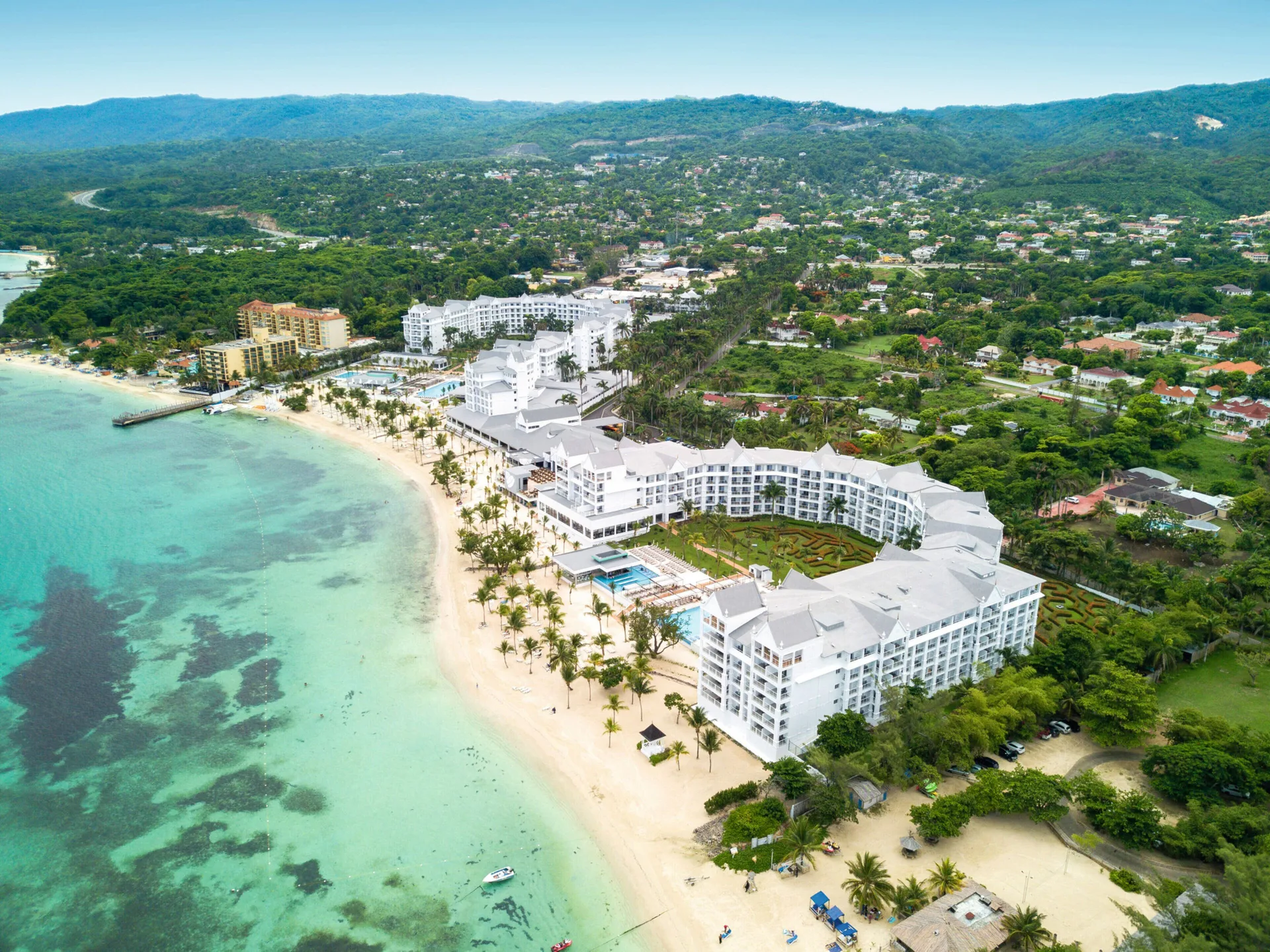 Aerial view of beachfront buildings and turquoise water at Hotel Riu Ocho Rios.